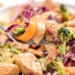 closeup view of keto stir fry with piece of chicken and vegetables on a fork