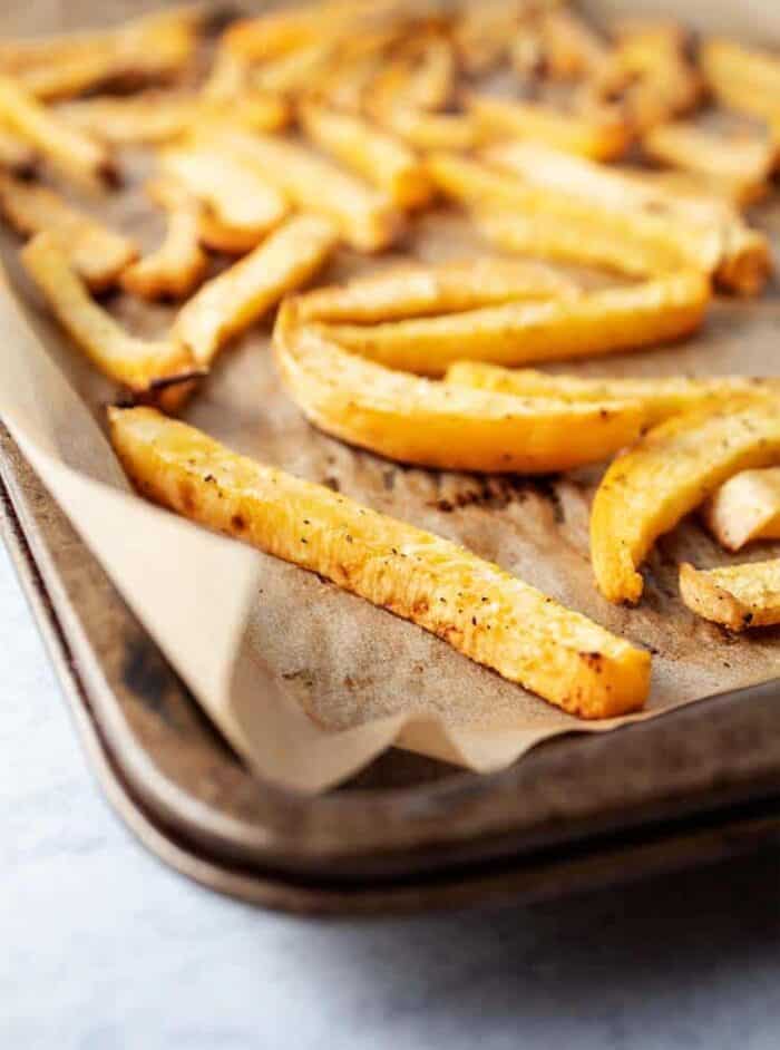 side of baking sheet with baked keto fries on top