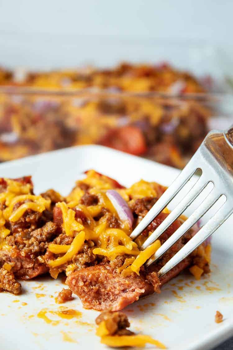 side view of keto chili cheese dog casserole being eaten with a fork