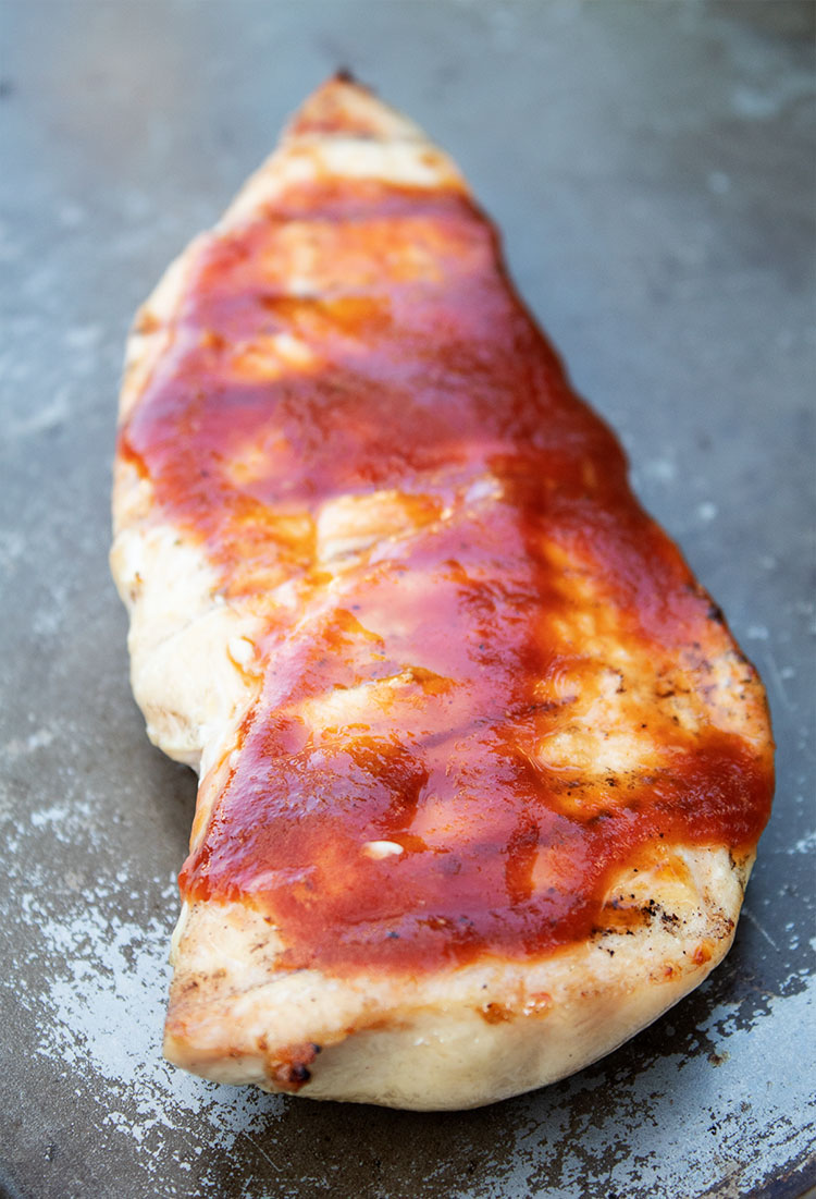 closeup of keto BBQ chicken breast brushed with sauce
