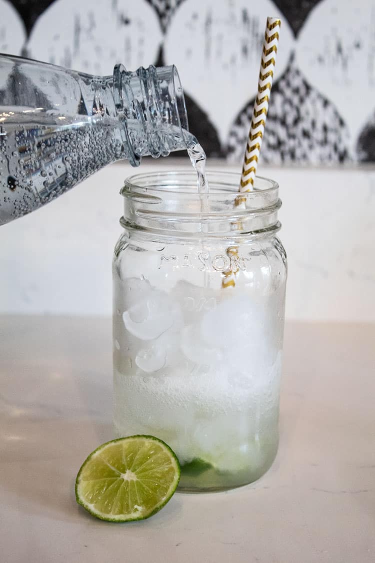 keto vodka soda in a glass with carbonated water being poured in