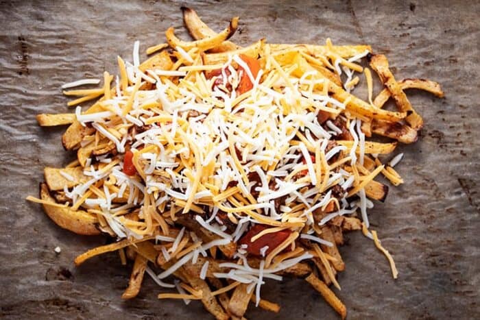 unbaked keto chili cheese fries on parchment paper