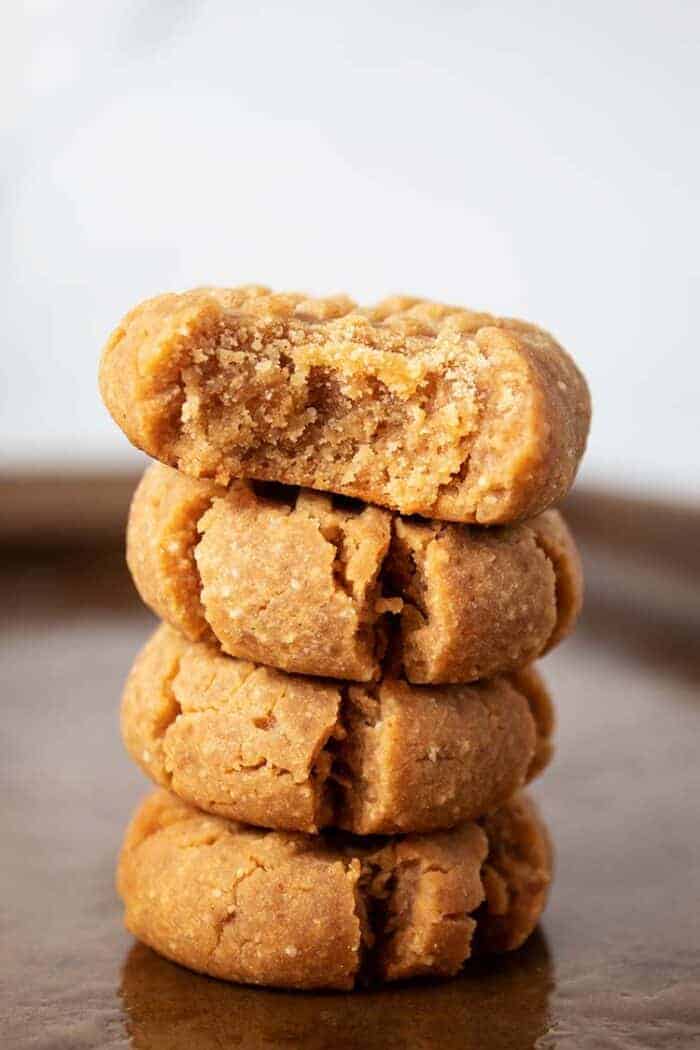 stack of 4 keto peanut butter cookies on sheet pan