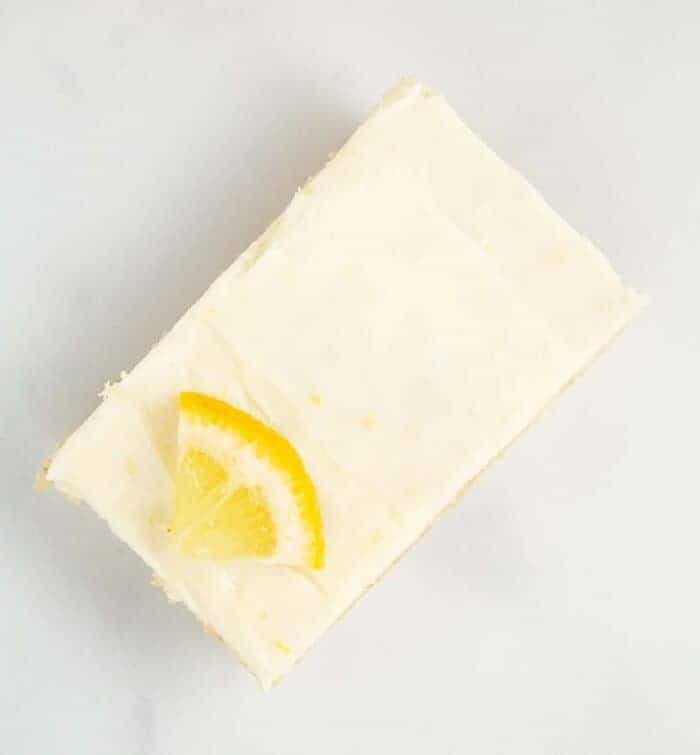 overhead view of keto lemon cookies with lemon slice on counter
