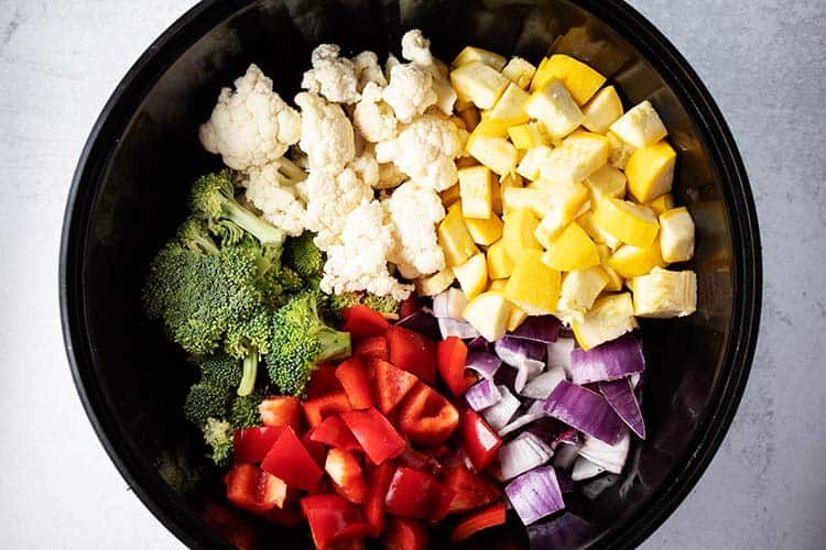chopped vegetables in a large black bowl