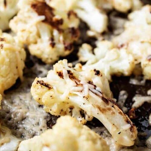 sheet pan with keto roasted cauliflower and melted parmesan cheese on it