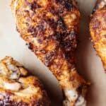 three air fryer chicken legs on parchment paper