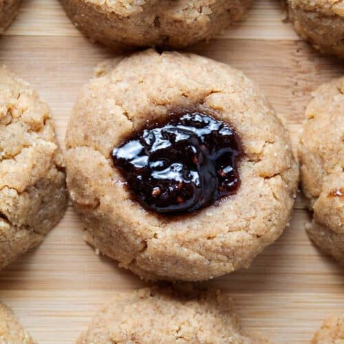 overhead view of pb and jelly cookies on wooden serving board