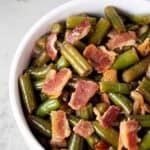 overhead view of bacon green beans in white serving bowl ready to serve