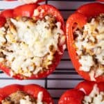 overhead view of six ready to serve keto stuffed peppers on a wire cooling rack