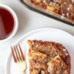 overhead view of a portion of keto french toast casserole on a serving dish next to the whole casserole