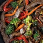 overhead view of broccoli steak stir fry ready to serve in stir fry pan