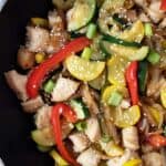 overhead view of chicken and zucchini stir fry in pan ready to serve