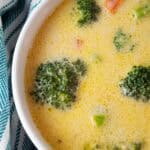 overhead view of white serving bowl of low carb keto broccoli cheddar cheese soup