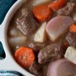 overhead view of keto beef stew in a white serving bowl ready to serve