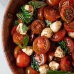 overhead view of caprese salad in a wooden serving dish