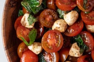 overhead view of caprese salad in a wooden serving dish