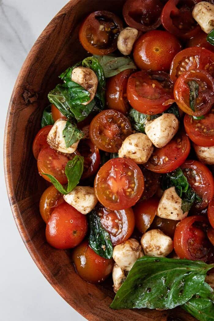overhead view of caprese salad in a wooden serving dish