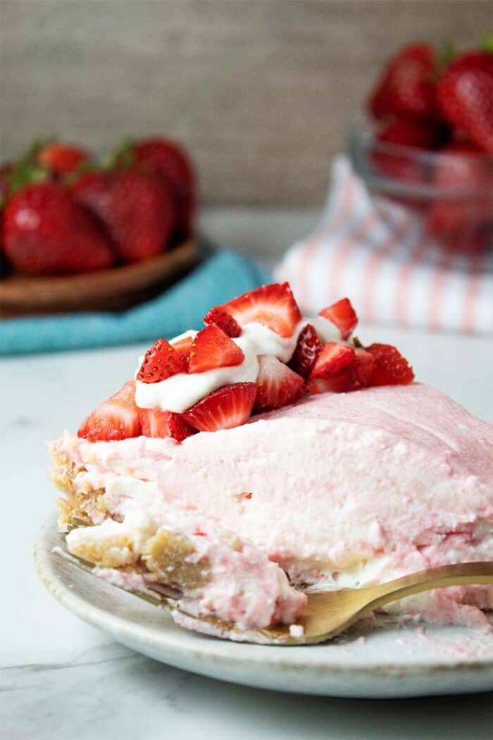 Side review of a portion of keto no-bake strawberry cheesecake on a dish.