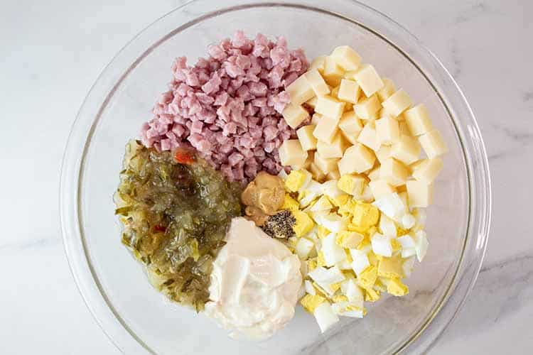 overhead view of each ingredient in a glass mixing bowl ready to be combined
