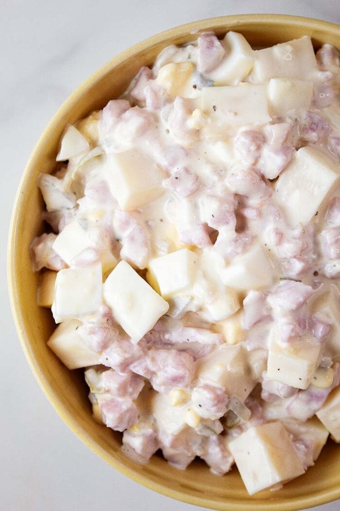 overhead view of ham salad ready to serve in a yellow bowl