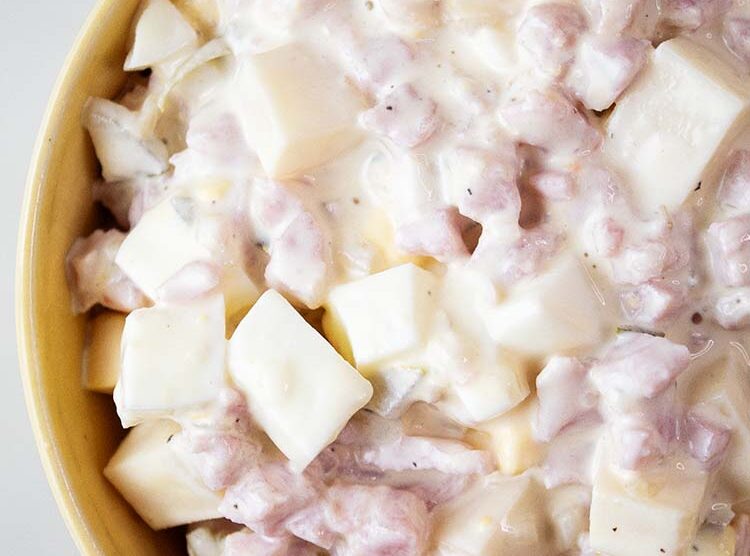 overhead view of ham salad ready to serve in a yellow bowl