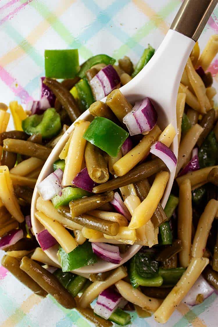 Overhead view of Keto bonens salad with a portion is removed with a white serving spoon
