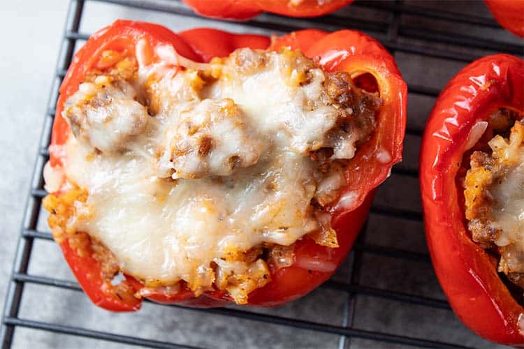 overhead closeup view of Italian sausage stuffed peppers on a wire cooling rack